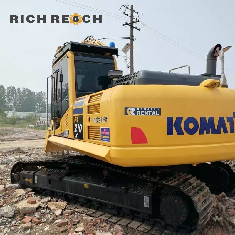 Undercarriage and track rollers of a 2018 Komatsu PC210 excavator priced at $30,556
